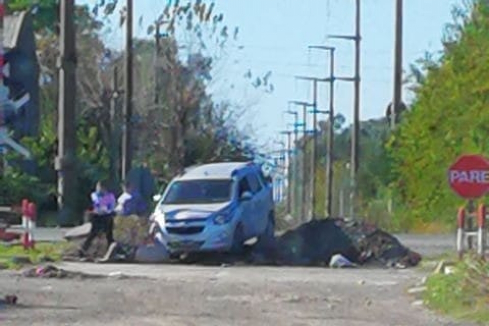 La Chrevolet clavada en el mont&iacute;culo. Uno de los ocupantes tirado debajo, sacando tierra.