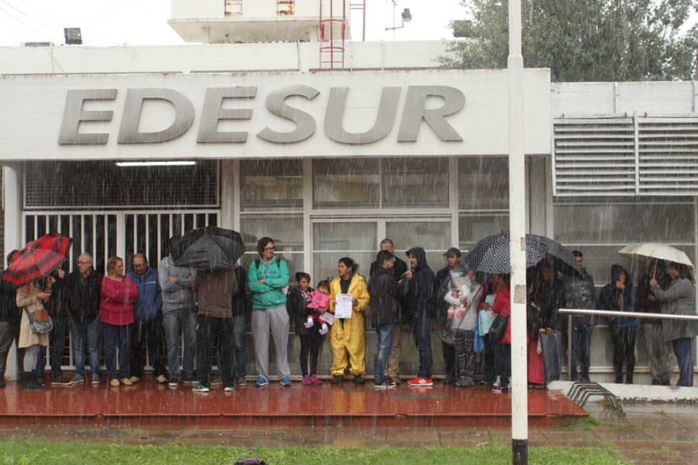 En medio de una intensa lluvia, vecinos y dirigentes se reunieron en la puerta de Edesur. 